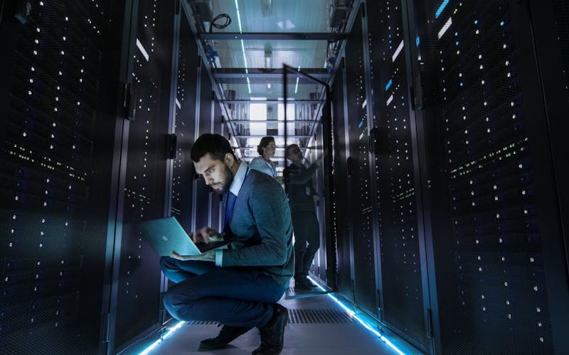 It,Technician,Works,On,Laptop,In,Big,Data,Center,Full