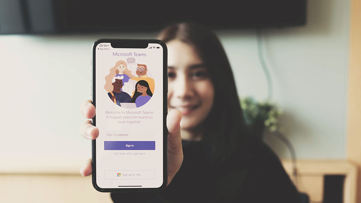 Girl working from home on Microsoft Teams call on her phone - Creating a Successful Microsoft Teams Phone Solution for a Global Manufacturing Customer with VOSS