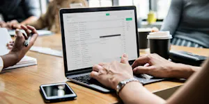 Woman checking her email in a meeting