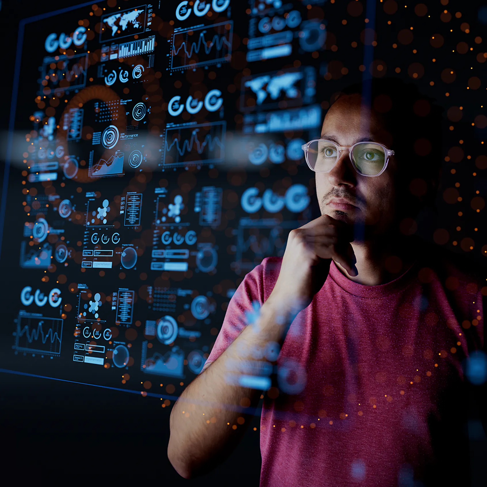 Dark background of Analyst looking at graphical data - used in VOSS blog for Maximizing Business Value with AI in UC: Cost Efficiency and New Opportunities