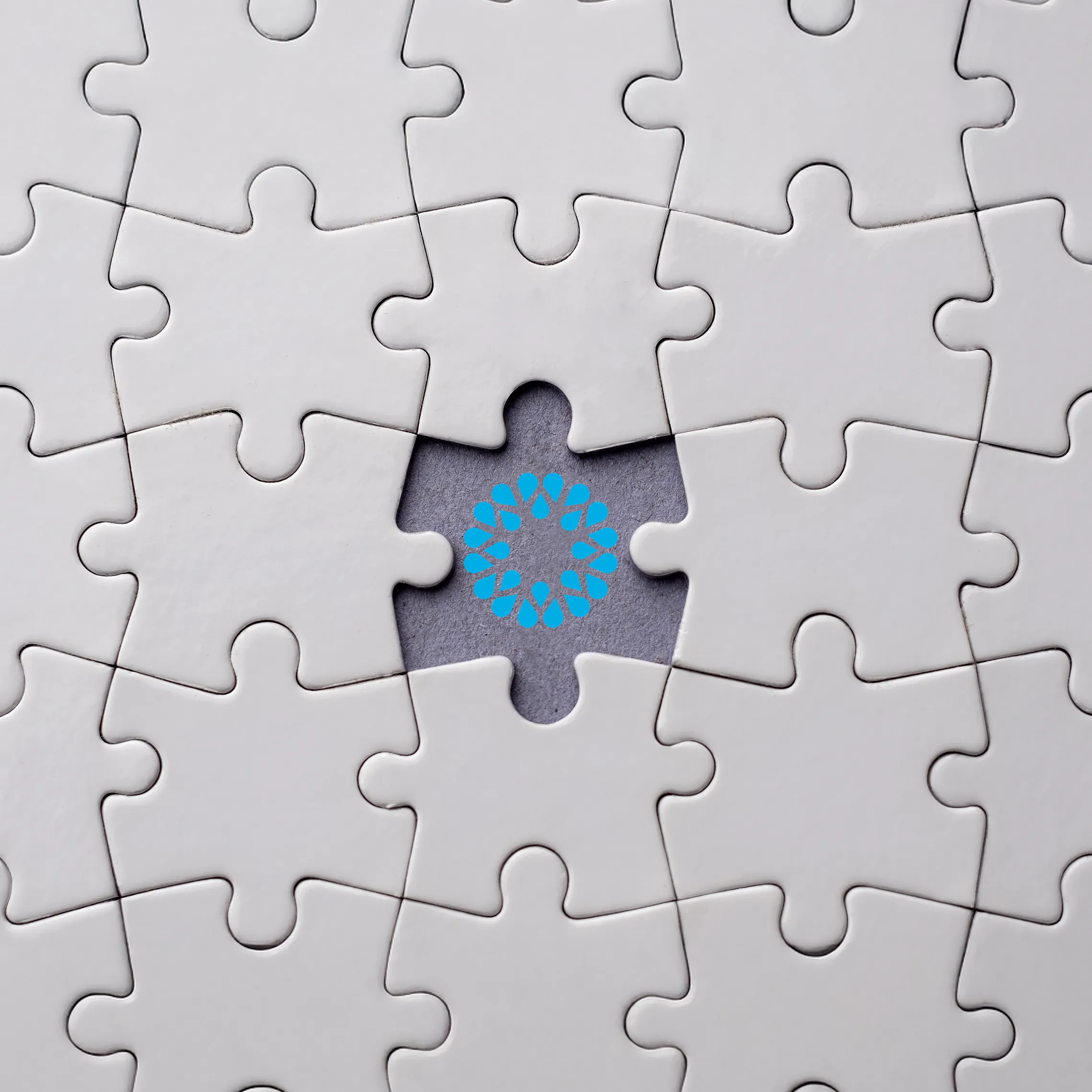 Plain white jigsaw with piece missing and filled with VOSS logo - used in 'Is UC analytics the missing layer in your business?' blog