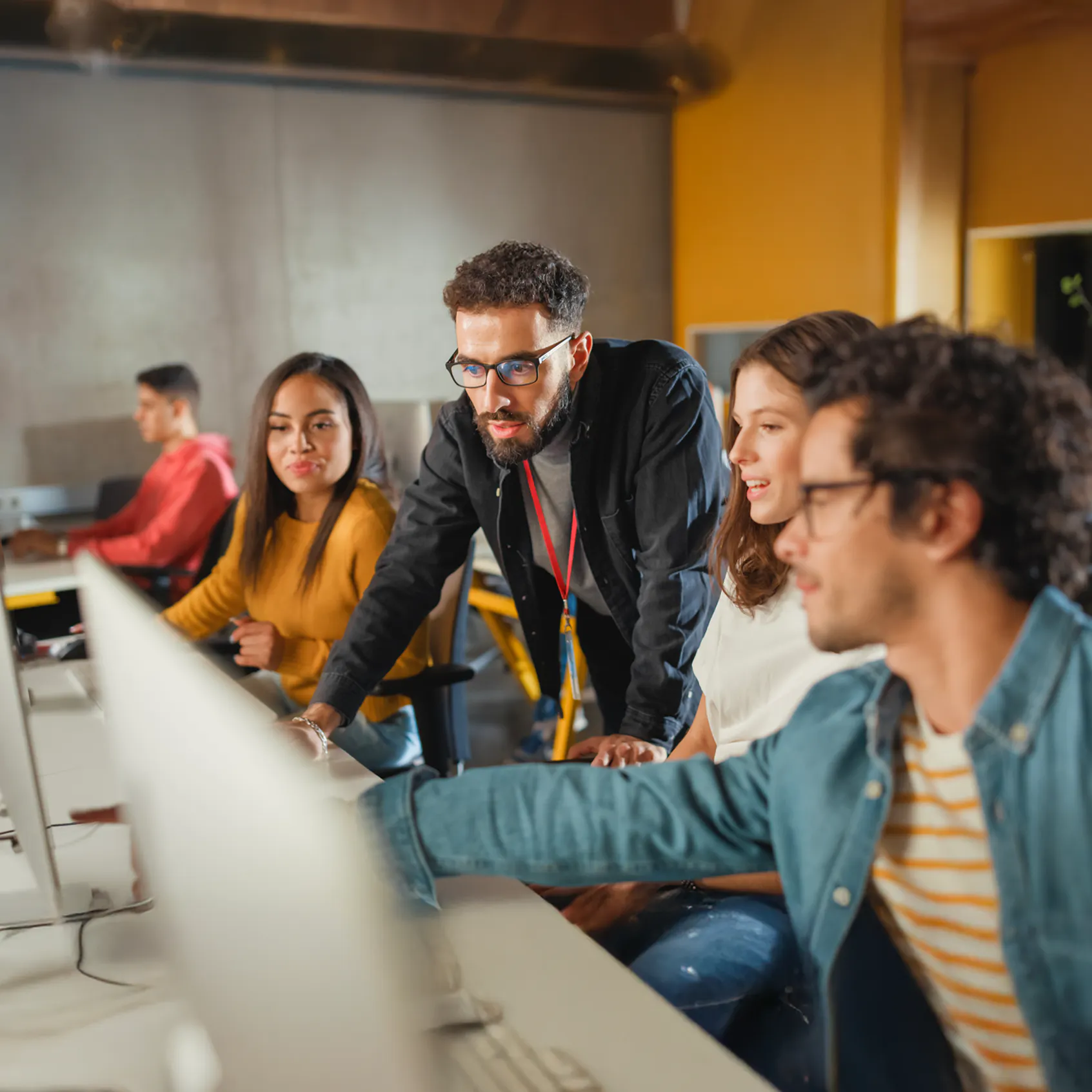 Why APAC organizations are rethinking digital workplace control blog image - Lecturer Helps Scholar with Project, Advising on Their Work. Teacher Giving Lesson to Diverse Multiethnic Group of Female and Male Students in College Room, Teaching New Academic Skills on a Computer.
