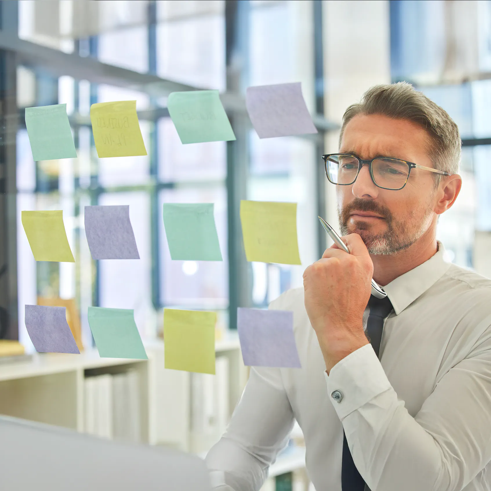 The visibility gap in Webex Calling deployments - image of business man thinking with lots of sticky notes for strategy planning UC ideas. Planning migration.