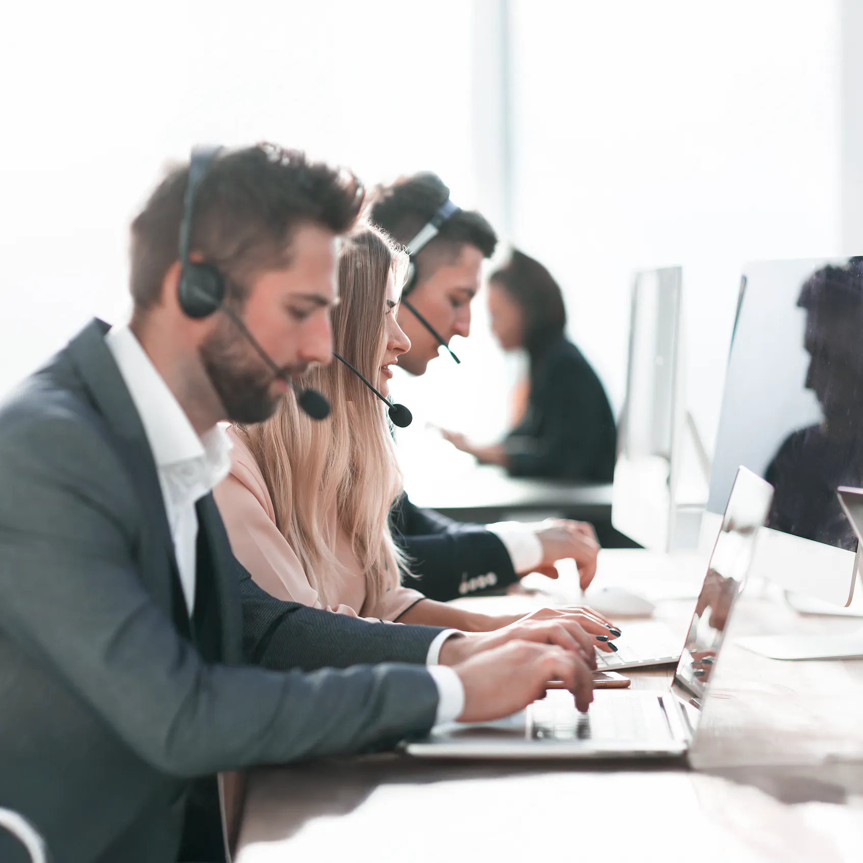 Driving efficiency in Webex Contact Center operations - call center operators using laptops and headsets to work with clients